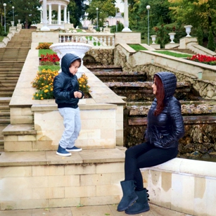 Mother and son playing in a rainy day in Chisinau, the capital of Moldova, by Omnimundi