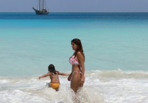 Beautiful Mrs Omnimundi entering her entering again in the water in a beach in the Seychelles
