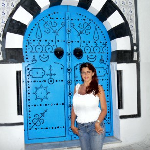 Mrs Omimundi standing at the famous Blue Door in Tunisia
