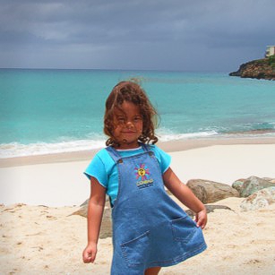 A young girl on a gorgeous beach in St. Marten in French Antilles