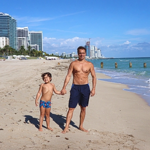 Father and young son standing in Miami Beach in front of the St Regis luxury hotel