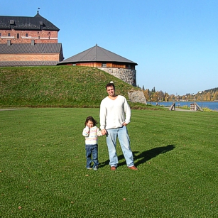 Father and son from Omnimundi family posing near an old castle in Hameenlinna Finland
