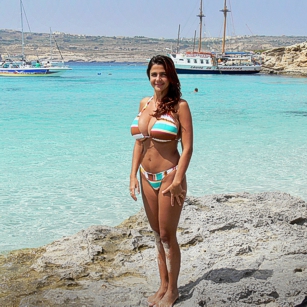 Fit woman in bikini posing in the Blue Lagoon in Malta, by Omnimundi