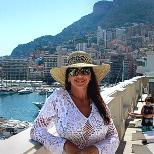 Woman in fancy dress poses inside a luxury hotel in Monaco for Omnimundi