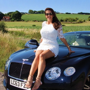 Omnimundi woman sitting on a luxury car in United Kingdom countryside