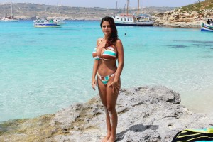 Fit woman in bikini posing at the Blue Lagoon in Malta, by Omnimundi