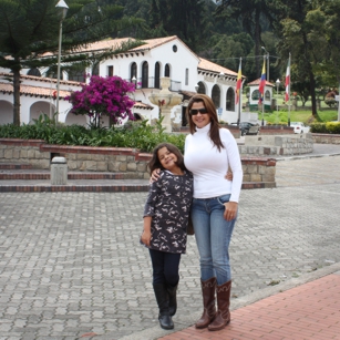 Mother and daughter with an old house in back ground in Zipaquira Colombia by Omnimundi Travel
