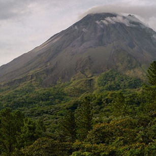 A huge Volcano covered by forests in a cloudy day