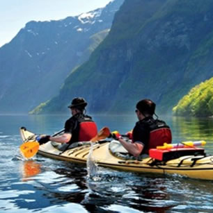 Two guys paddling a Kayak during an adventure travel