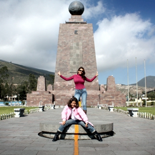People standing on the mark zero point on equator line in Quito, Ecuador